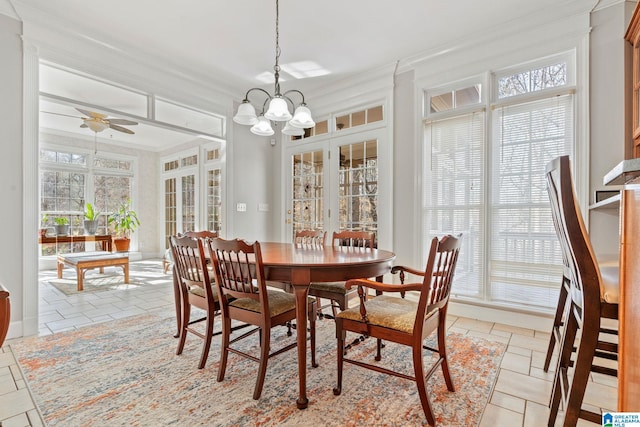 dining area with ceiling fan with notable chandelier and ornamental molding