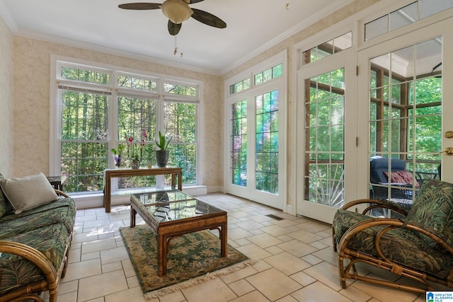 sunroom / solarium featuring french doors and ceiling fan