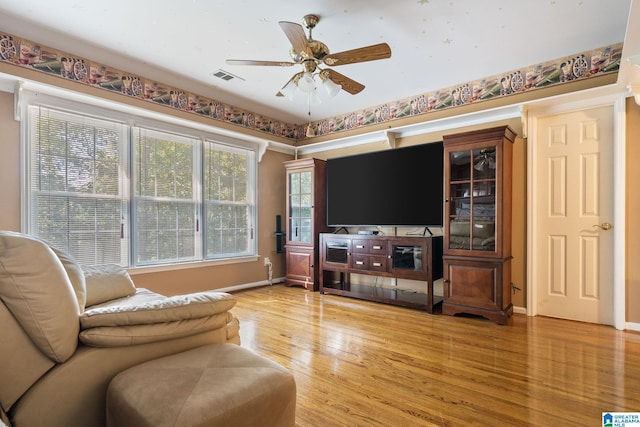 living room featuring ceiling fan and hardwood / wood-style floors