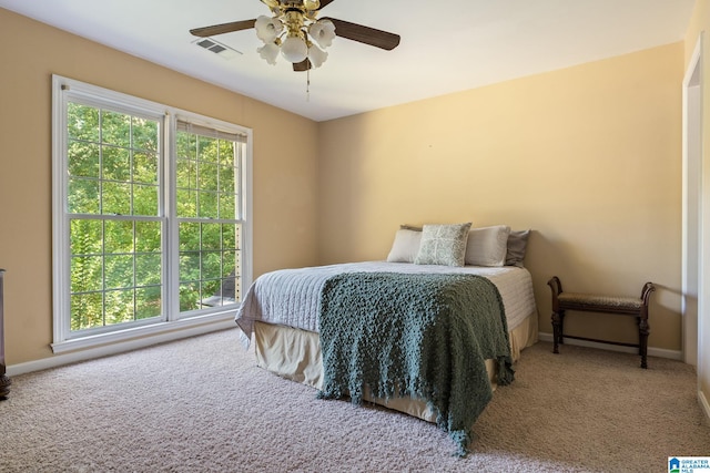 bedroom featuring carpet, multiple windows, and ceiling fan