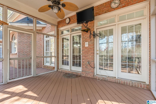 unfurnished sunroom with ceiling fan