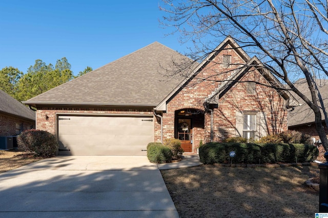 front of property featuring cooling unit and a garage