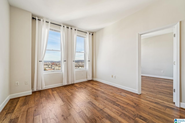 empty room featuring dark wood-type flooring