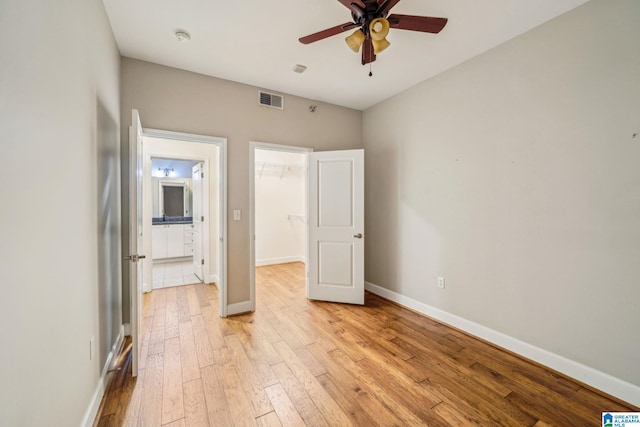 unfurnished bedroom featuring ceiling fan and light wood-type flooring