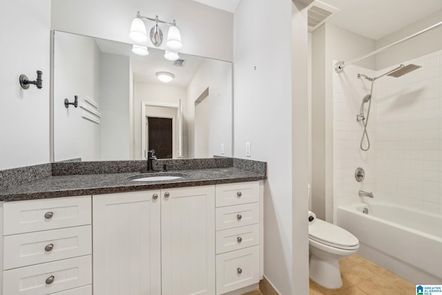 full bathroom with washtub / shower combination, tile patterned flooring, vanity, and toilet