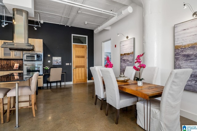 dining space featuring a high ceiling