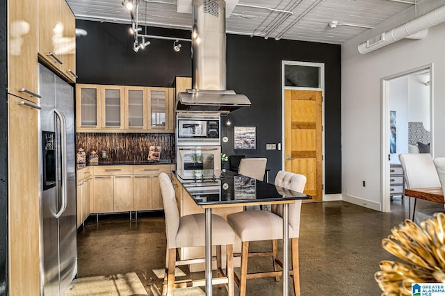 kitchen with backsplash, light brown cabinetry, island exhaust hood, and appliances with stainless steel finishes