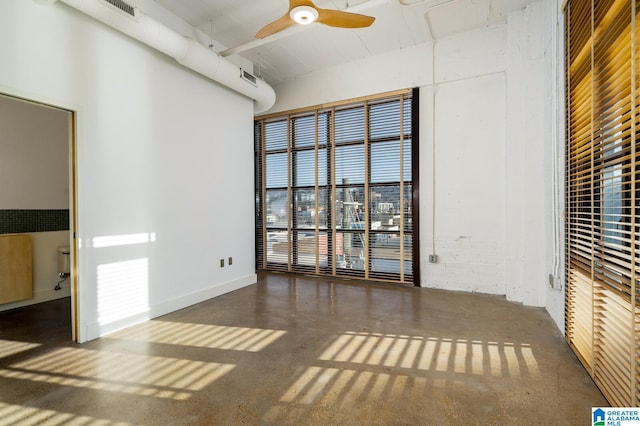 empty room with a high ceiling and ceiling fan