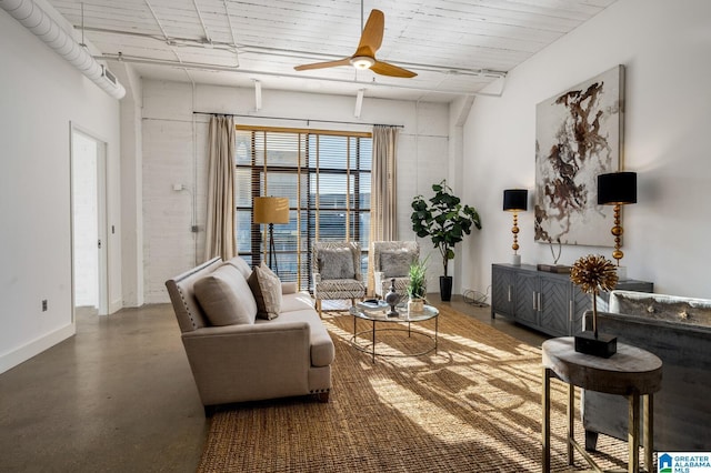 living room with concrete flooring and ceiling fan