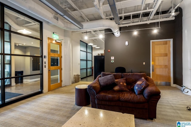 living room featuring light colored carpet and a towering ceiling