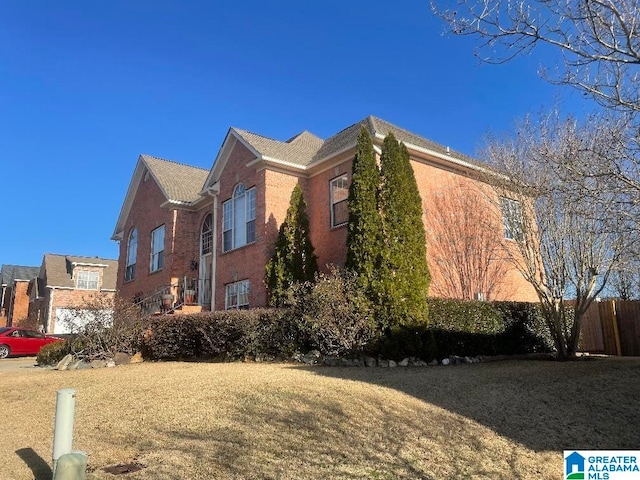 view of side of property with a yard