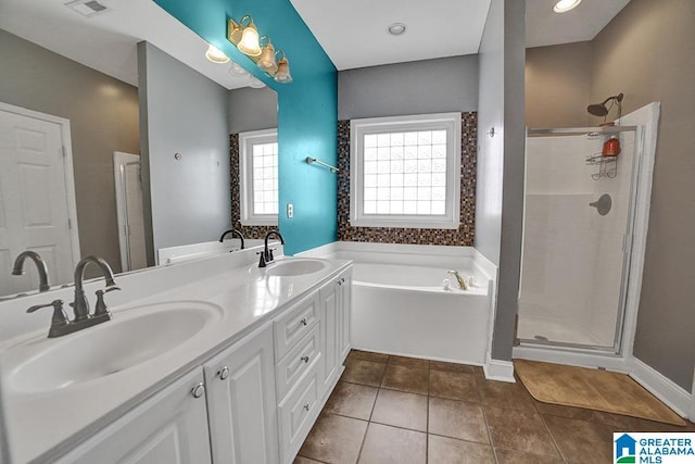 bathroom with tile patterned flooring, vanity, and shower with separate bathtub