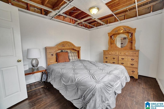 bedroom with dark hardwood / wood-style floors