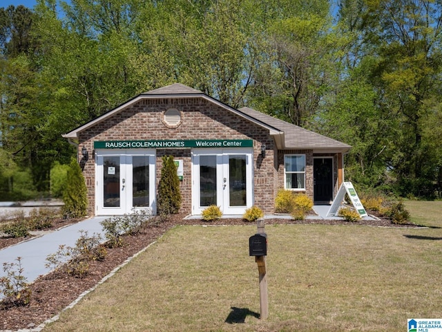 view of front of home featuring a front yard and french doors