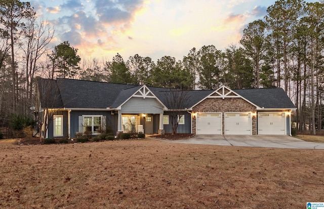 view of front facade with a yard and a garage