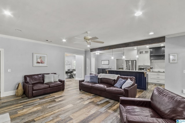 living room with dark hardwood / wood-style floors, ceiling fan, and ornamental molding