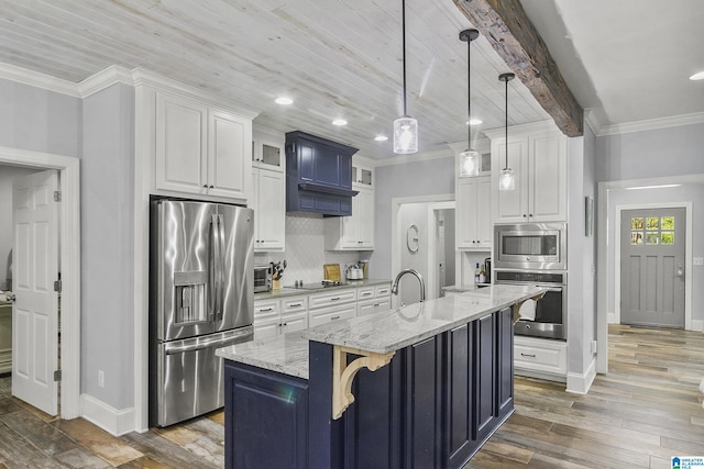 kitchen with a center island with sink, dark hardwood / wood-style floors, decorative light fixtures, light stone counters, and stainless steel appliances