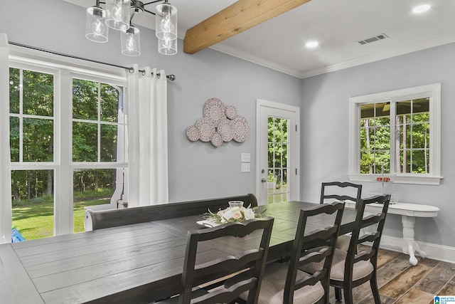 dining area featuring beamed ceiling, plenty of natural light, and ornamental molding