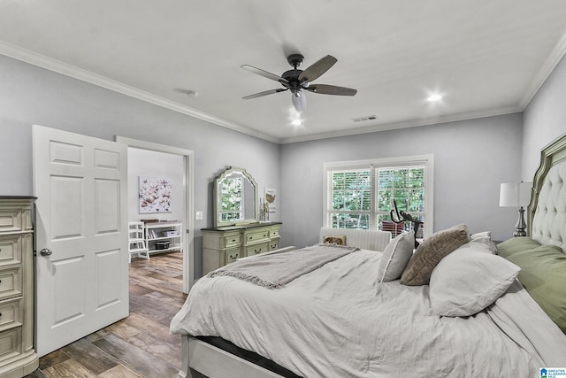 bedroom with hardwood / wood-style flooring, ceiling fan, and ornamental molding