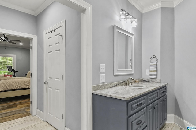 bathroom with ceiling fan, vanity, and ornamental molding