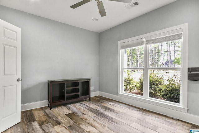 spare room featuring hardwood / wood-style floors and ceiling fan