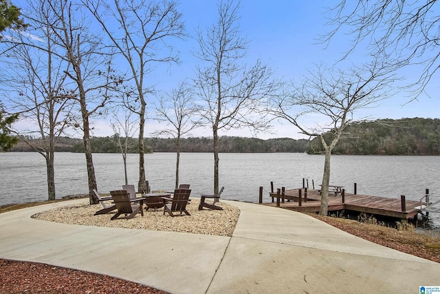 view of dock featuring a water view and a fire pit