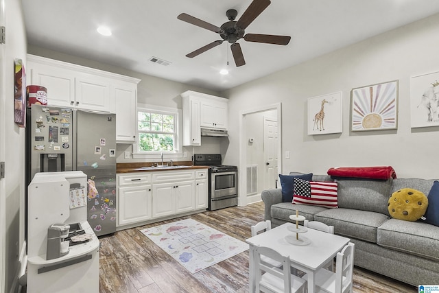 living room featuring ceiling fan, dark wood-type flooring, and sink