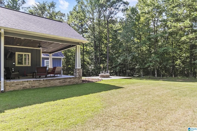 view of yard with ceiling fan and a patio area