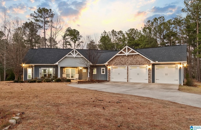 view of front of house with a yard and a garage