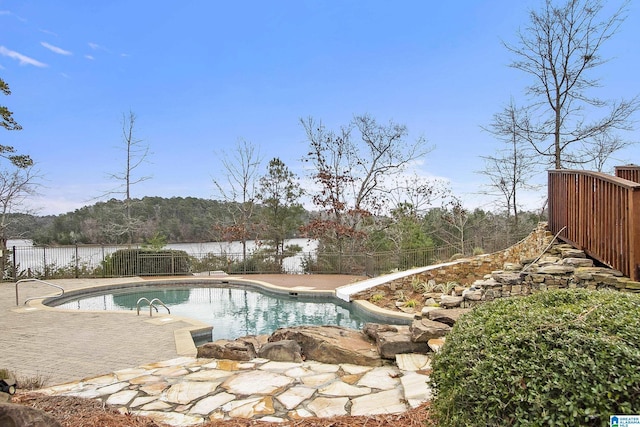 view of swimming pool featuring a diving board