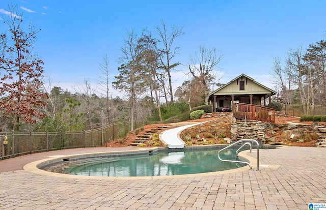 view of swimming pool with a patio area and a water slide