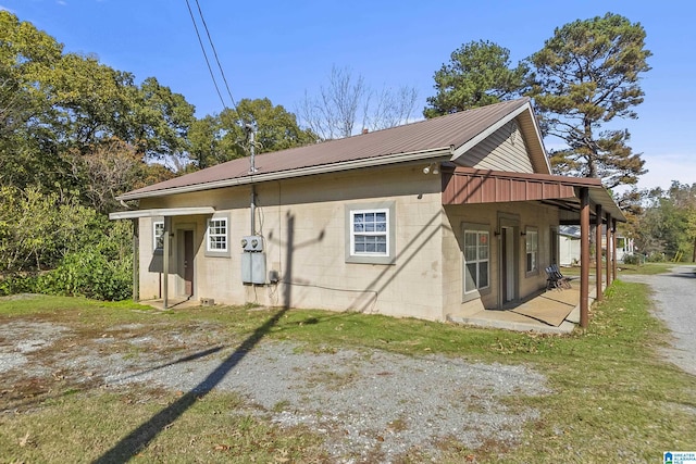 back of house featuring a patio area and a lawn