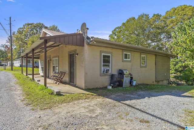 view of side of home featuring a patio and cooling unit