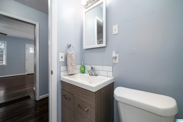 bathroom featuring hardwood / wood-style floors, vanity, and toilet