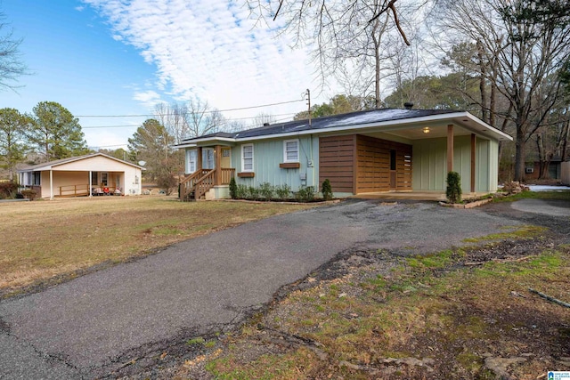 ranch-style home with a front lawn and a carport