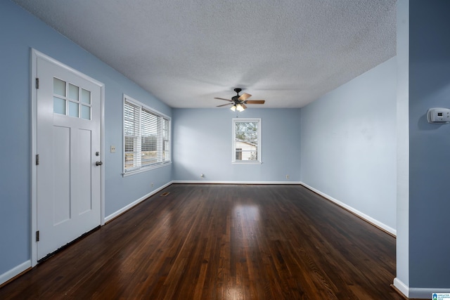 entryway featuring a textured ceiling, dark hardwood / wood-style floors, and ceiling fan