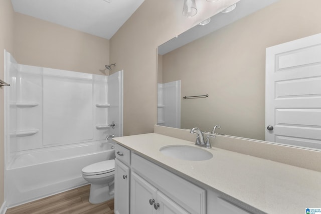 full bathroom featuring toilet, vanity, washtub / shower combination, and hardwood / wood-style floors