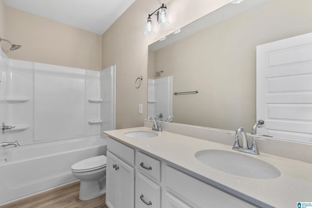 full bathroom with toilet, vanity, shower / bath combination, and hardwood / wood-style floors