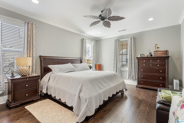 bedroom featuring ceiling fan, ornamental molding, and dark wood-type flooring