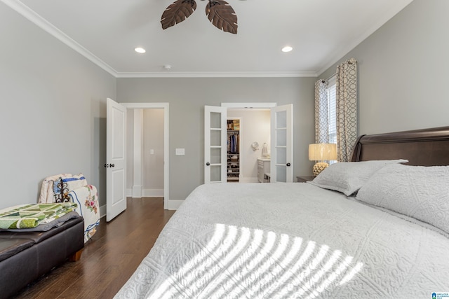 bedroom with a walk in closet, ceiling fan, dark hardwood / wood-style flooring, and ornamental molding