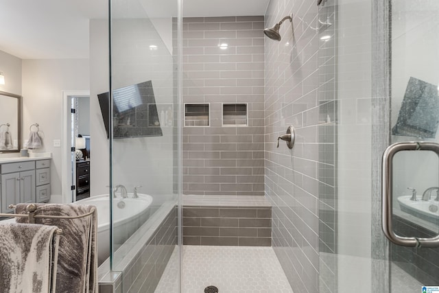 bathroom featuring plus walk in shower and vanity