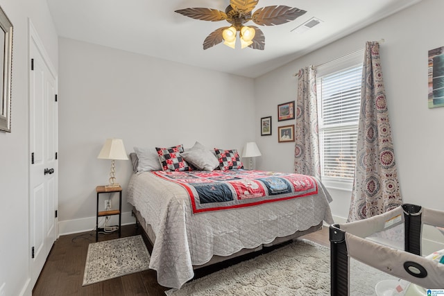 bedroom with ceiling fan and dark hardwood / wood-style floors