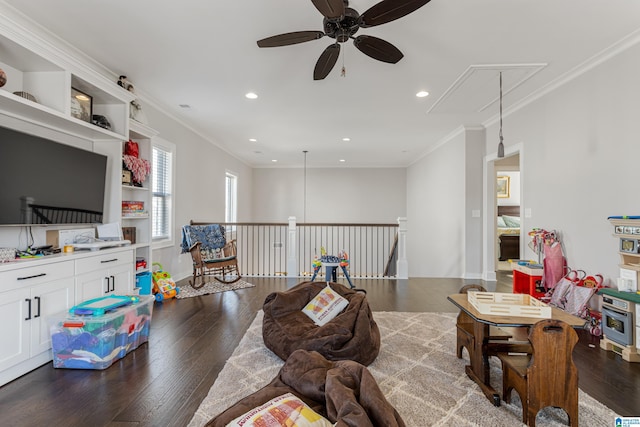 living room featuring dark hardwood / wood-style flooring, ceiling fan, and crown molding