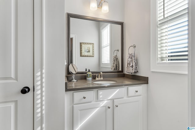 bathroom with a chandelier and vanity