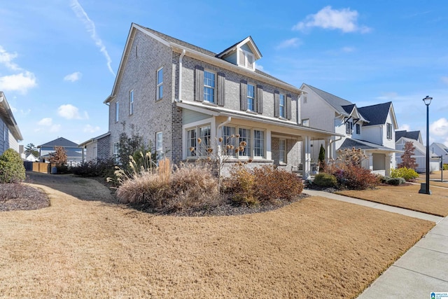 view of front of home featuring a porch and a front lawn