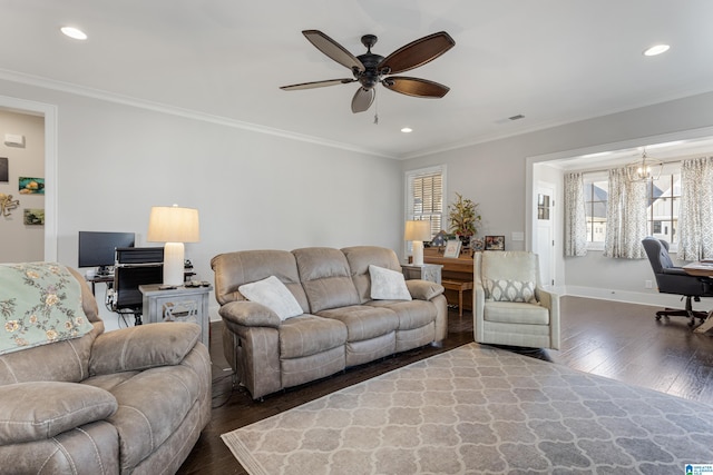 living room featuring ornamental molding, dark hardwood / wood-style flooring, plenty of natural light, and ceiling fan with notable chandelier