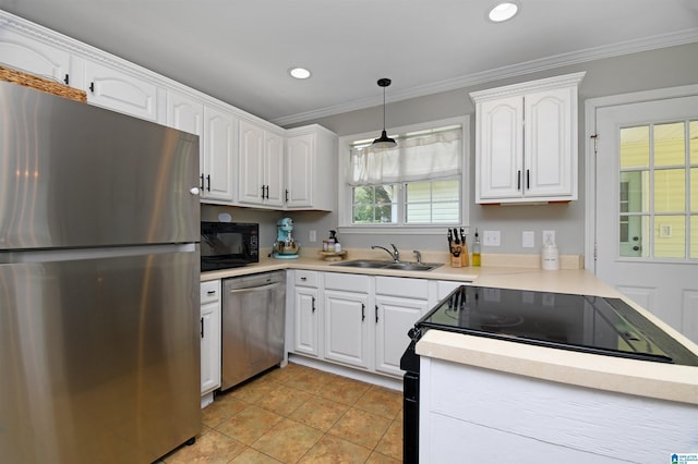 kitchen with white cabinets, appliances with stainless steel finishes, decorative light fixtures, and sink