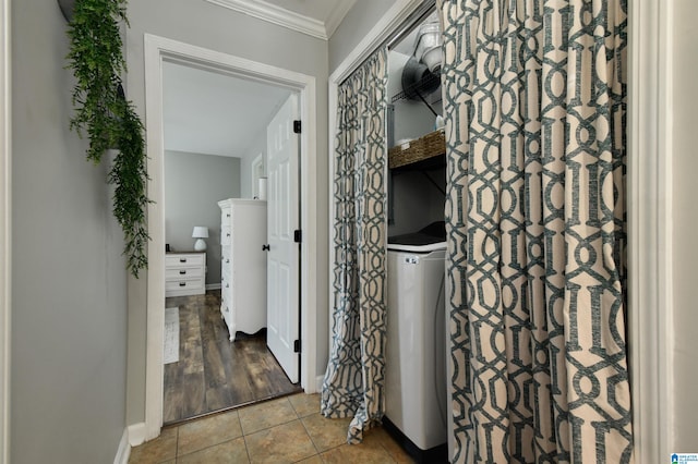 corridor with crown molding and tile patterned flooring