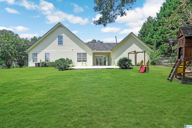 rear view of house with a yard, a playground, and a patio