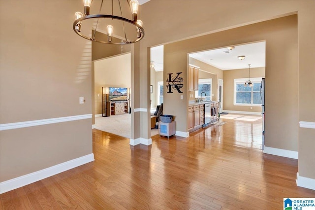 interior space featuring sink, a chandelier, and light hardwood / wood-style floors